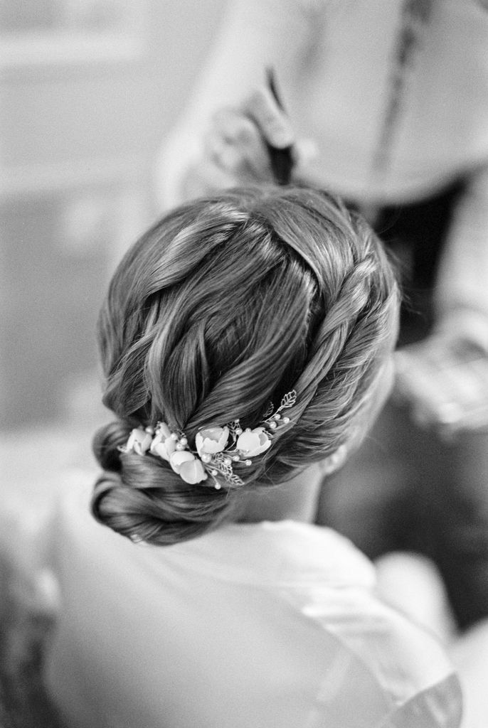 Chic bridal hairstyle with flowers, captured in black and white for a timeless look.